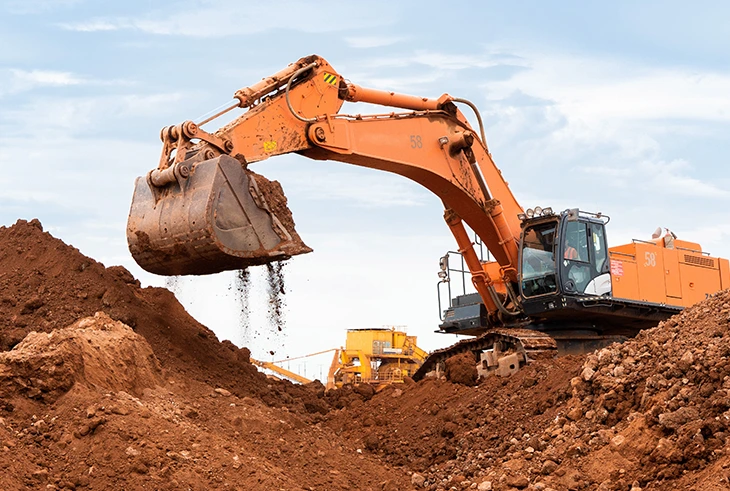 Excavator working in an extractive industry site